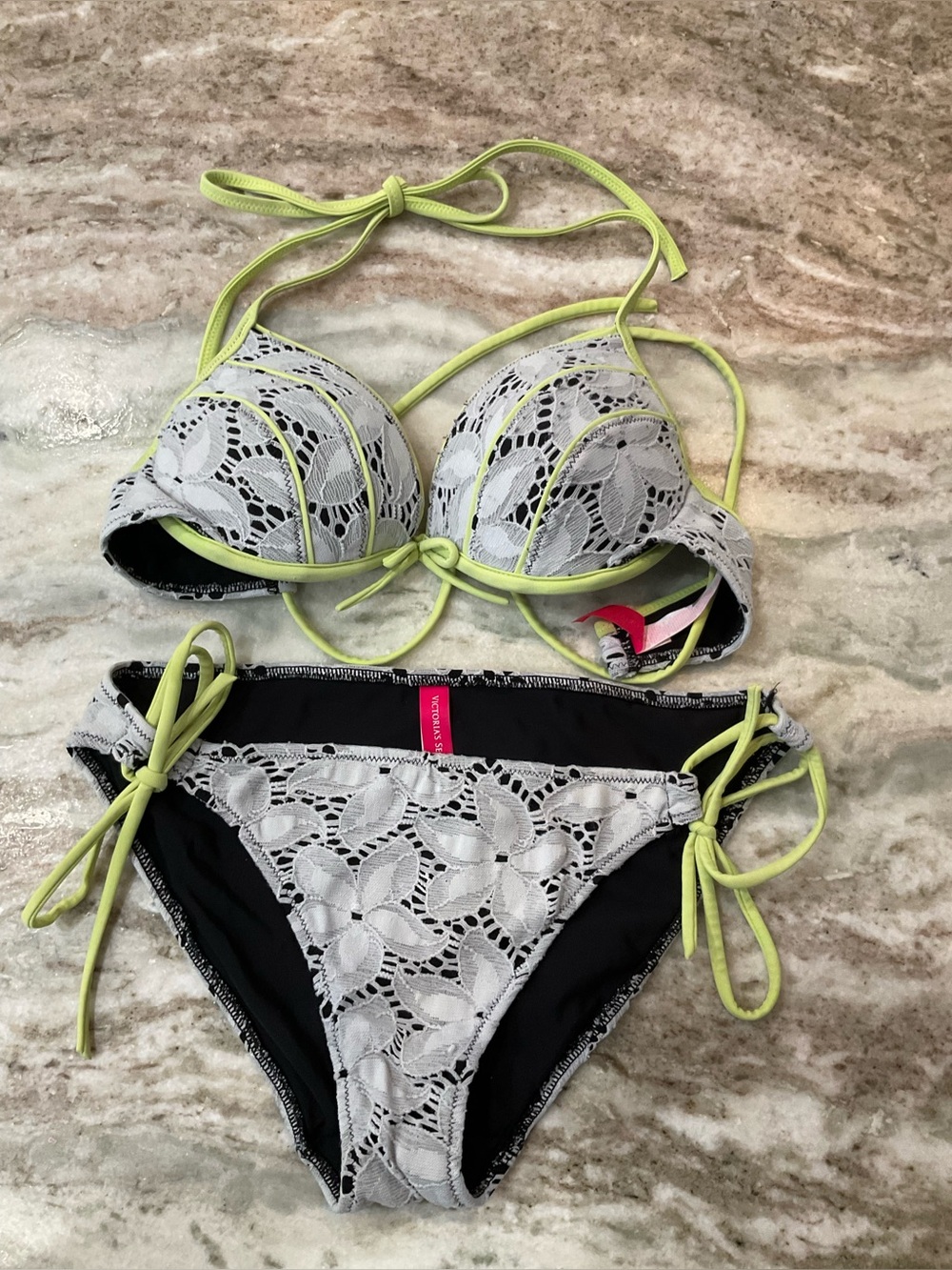 Victoria's Secret bikini set featuring white lace overlay with neon green trim.